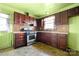 Galley kitchen featuring wood cabinets, stainless steel stove, and durable countertops at 728 Dedmon Dr, Charlotte, NC 28216