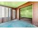 Bright sunroom with brick accents and transition to the living area at 728 Dedmon Dr, Charlotte, NC 28216