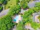 Overhead view of a community pool and tennis court surrounded by lush trees and well-maintained grounds at 803 Lake Club Dr, Rock Hill, SC 29732