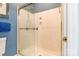 Bathroom featuring a glass-enclosed shower with gold hardware and blue patterned wallpaper at 803 Lake Club Dr, Rock Hill, SC 29732