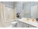 Traditional bathroom with a tub and shower combination, patterned wallpaper, and a single sink vanity at 803 Lake Club Dr, Rock Hill, SC 29732