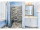 Elegant bathroom with a tiled walk-in shower and vanity with light blue walls at 803 Lake Club Dr, Rock Hill, SC 29732