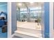 Bright bathroom featuring a large soaking tub and mirrored vanity with abundant lighting at 803 Lake Club Dr, Rock Hill, SC 29732