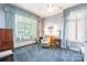 Spacious bedroom with a bay window and cushioned seating, with beautiful window and wall decor at 803 Lake Club Dr, Rock Hill, SC 29732