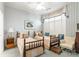Bedroom with two twin beds, blue and white wallpaper, and a window seat at 803 Lake Club Dr, Rock Hill, SC 29732