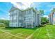 Charming condo building with lake views, enclosed porch, and lush lawn in a beautiful residential community at 803 Lake Club Dr, Rock Hill, SC 29732