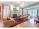 Cozy living room featuring a fireplace, hardwood floors, and access to the sunroom at 803 Lake Club Dr, Rock Hill, SC 29732