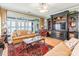 Spacious living room with a built-in entertainment center, hardwood floors, and lake views at 803 Lake Club Dr, Rock Hill, SC 29732