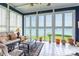Bright sunroom with large windows offering stunning lake views and seating area at 803 Lake Club Dr, Rock Hill, SC 29732