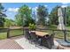 Backyard deck featuring an outdoor dining table with seating and an umbrella at 8211 Abbottsgate Ln, Charlotte, NC 28269