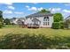 Spacious backyard with a grassy lawn and a view of the house, featuring a deck at 8211 Abbottsgate Ln, Charlotte, NC 28269