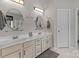 Bright bathroom boasting double sinks, stylish mirrors, and ample vanity storage at 8211 Abbottsgate Ln, Charlotte, NC 28269