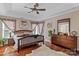 Primary bedroom featuring hardwood floors, large windows, and a tray ceiling at 8211 Abbottsgate Ln, Charlotte, NC 28269