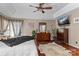 Large main bedroom featuring tray ceiling, hardwood floors and natural light at 8211 Abbottsgate Ln, Charlotte, NC 28269