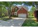 Charming brick home with a well-manicured lawn and a large shade tree in a desirable neighborhood at 8211 Abbottsgate Ln, Charlotte, NC 28269