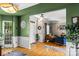 Open-concept foyer leads to a living room, showcasing hardwood floors and natural light at 8211 Abbottsgate Ln, Charlotte, NC 28269