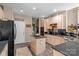 Spacious kitchen featuring stainless steel appliances, an island, and access to the dining area at 8211 Abbottsgate Ln, Charlotte, NC 28269