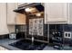 Close-up of cooktop and decorative backsplash, highlighting stainless steel appliances at 8211 Abbottsgate Ln, Charlotte, NC 28269