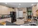 Bright kitchen featuring an island, stainless steel refrigerator, and ample cabinet space at 8211 Abbottsgate Ln, Charlotte, NC 28269