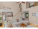 Bright living room with a large sectional, high ceilings, and staircase leading to the second floor at 8211 Abbottsgate Ln, Charlotte, NC 28269