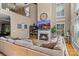 Open living room featuring a fireplace, large windows with shutters, and a comfortable sectional sofa at 8211 Abbottsgate Ln, Charlotte, NC 28269