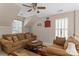 Comfortable living room with vaulted ceiling, lots of natural light and a ceiling fan at 8211 Abbottsgate Ln, Charlotte, NC 28269