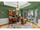 Well-lit home office with ample storage, hardwood floors, and a peaceful workspace at 8211 Abbottsgate Ln, Charlotte, NC 28269