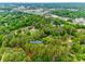 An aerial view of neighborhood with lush greenery and mature trees close to shopping and commerce at 8525 Castlekeep Rd # 26, Charlotte, NC 28226