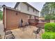 Spacious patio with lounge chairs and a tiered deck extending from the brick home at 8525 Castlekeep Rd # 26, Charlotte, NC 28226