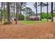 Expansive backyard featuring a shed, a small wooden deck, and mature trees that offer ample shade at 8525 Castlekeep Rd # 26, Charlotte, NC 28226