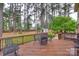 Relaxing outdoor deck space with dining table surrounded by lush greenery and tall trees at 8525 Castlekeep Rd # 26, Charlotte, NC 28226