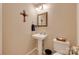 Half bath featuring a pedestal sink, tile floors, and a decorative mirror at 8525 Castlekeep Rd # 26, Charlotte, NC 28226