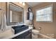 Modern bathroom with a black sink, decorative mirror, and a storage cabinet at 8525 Castlekeep Rd # 26, Charlotte, NC 28226