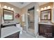 Modern bathroom with double vanity, granite countertops, and a glass-enclosed shower at 8525 Castlekeep Rd # 26, Charlotte, NC 28226