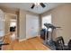 Bedroom with a fitness machine, hardwood floors and open access to the hallway at 8525 Castlekeep Rd # 26, Charlotte, NC 28226