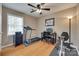 Well-lit bedroom featuring workout equipment, hardwood flooring, and a desk at 8525 Castlekeep Rd # 26, Charlotte, NC 28226