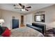 Well-lit bedroom with a ceiling fan, dresser, and a view to the hallway at 8525 Castlekeep Rd # 26, Charlotte, NC 28226