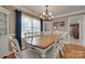 Elegant dining room with a large wooden table, white chairs, and natural light at 8525 Castlekeep Rd # 26, Charlotte, NC 28226