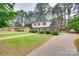 Spacious two-story house with a lush lawn, mature trees, and a long driveway at 8525 Castlekeep Rd # 26, Charlotte, NC 28226