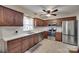 Modern kitchen with stainless steel appliances, white countertops, and dark wood cabinetry at 8525 Castlekeep Rd # 26, Charlotte, NC 28226