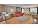 Bright and airy living room with hardwood floors, a large area rug, and classic furnishings at 8525 Castlekeep Rd # 26, Charlotte, NC 28226