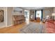 Spacious living room featuring hardwood floors, a vintage piano, and comfortable seating at 8525 Castlekeep Rd # 26, Charlotte, NC 28226