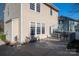 A well-lit backyard featuring a neutral-toned house, patio, and a wooden deck at 8532 Westmoreland Lake Dr, Cornelius, NC 28031