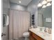 Functional bathroom features a vanity and shower with a privacy curtain, providing essential amenities at 8532 Westmoreland Lake Dr, Cornelius, NC 28031