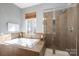 Bright bathroom features a tub and a tiled shower with glass door, offering a relaxing spa-like experience at 8532 Westmoreland Lake Dr, Cornelius, NC 28031
