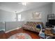 Bedroom with a futon, desk, hardwood floors and a ceiling fan at 8532 Westmoreland Lake Dr, Cornelius, NC 28031