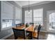 Bright dining area with a wooden table, black chairs, and large windows at 8532 Westmoreland Lake Dr, Cornelius, NC 28031