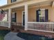 Inviting front porch featuring classic rocking chairs, perfect for enjoying the outdoors at 8532 Westmoreland Lake Dr, Cornelius, NC 28031