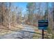 McDowell Creek Greenway features a paved trail, lush trees, and a nearby sign at 8532 Westmoreland Lake Dr, Cornelius, NC 28031