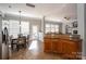 Open kitchen and dining area with granite countertops, wood cabinetry, and plenty of natural light at 8532 Westmoreland Lake Dr, Cornelius, NC 28031